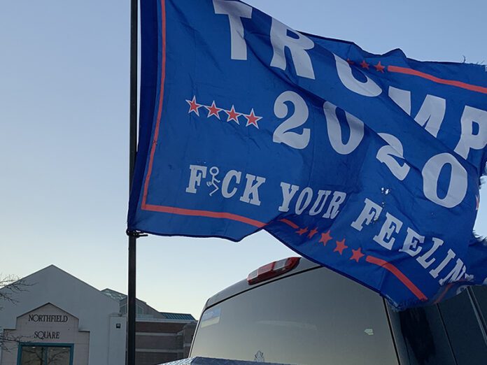 tattered trump flag flies after biden wins election november 7th
